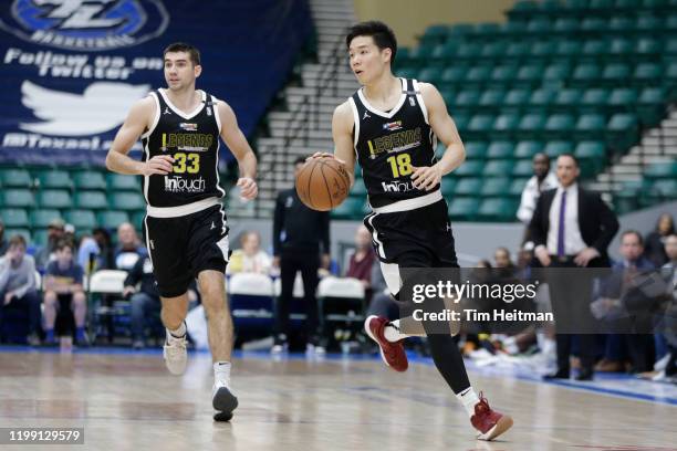 Yudai Baba of the Texas Legends dribbles up court with Dakota Mathias of the Texas Legends during the third quarter against the Agua Caliente...