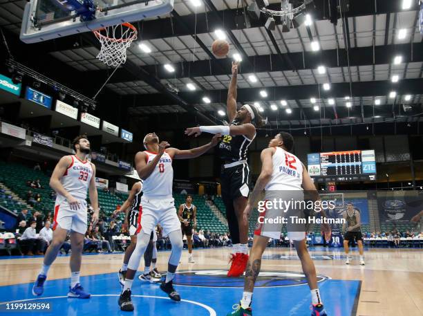 Chad Brown of the Texas Legends shoots over Donte Grantham of the Agua Caliente Clippers and James Palmer of the Agua Caliente Clippers during the...