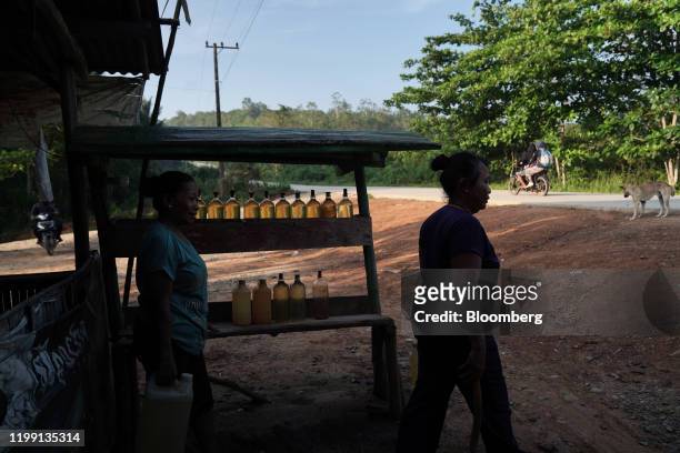 Street vendors sell gasoline in bottles on the side of a road in East Kalimantan, Borneo, Indonesia, on Wednesday, Nov. 27, 2019. For Jakarta, a city...