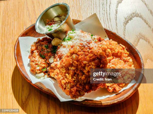 fried chicken with crispy grain skin in wooden plate - chicken strip stock pictures, royalty-free photos & images