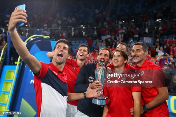 Novak Djokovic of Serbia poses for a selfie with team mates after winning the ATP Cup final against Spain during day 10 of the ATP Cup at Ken...