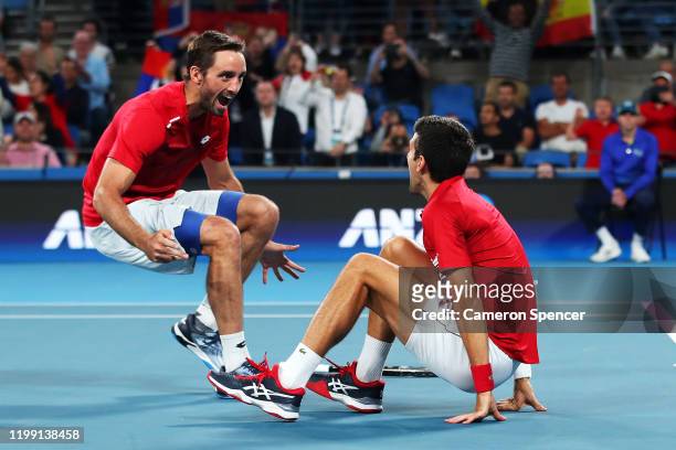Novak Djokovic of Serbia celebrates with Viktor Troicki of Serbia after winning their doubles final against Feliciano Lopez and Pablo Carreno Busta...