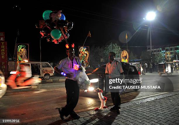 Street vendors sell toys on the banks of Dal Lake in Srinagar on July 26,2011. The tourism industry is hoping that cool summer weather will herald a...