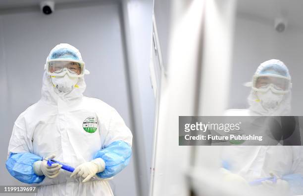 Staff works in the pop-up Huoyan Laboratory specialized in the nucleic acid test on 2019-nCoV in Wuhan in central China's Hubei province Thursday,...