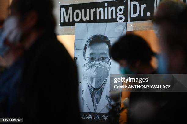 People attend a vigil in Hong Kong on February 7, 2020 for novel coronavirus whistleblowing doctor Li Wenliang who died in Wuhan after contracting...