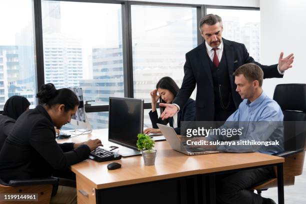 the frustrated ceo is angry with his co-worker during an office meeting. - bossy fotografías e imágenes de stock