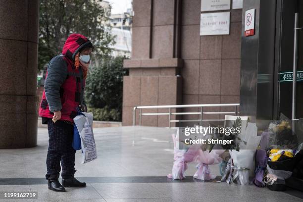 Woman grieves while paying tribute to Dr. Li Wenliang at Li's hospital in Wuhan in central China's Hubei province on Februsry 7, 2020 in Wuhan,...