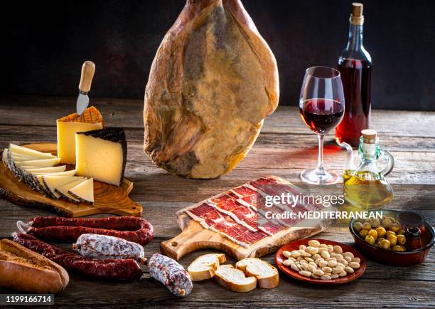 iberian ham leg hanged cheese and wine - smoked stock pictures, royalty-free photos & images