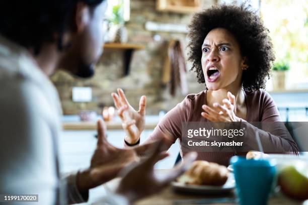 angry african american couple arguing during breakfast at home. - angry black woman stock pictures, royalty-free photos & images