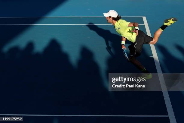 Jordan Thompson of Australia, partnered Lleyton Hewitt serves in the doubles match against Cristian Garin of Chile and Juan Ignacio Londero of...