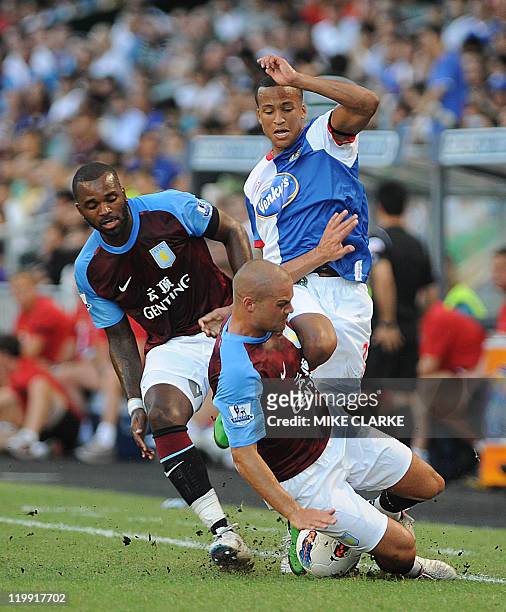 Martin Olsson of Blackburn battles for the ball with Darren Bent of Aston Villa and Luke Young of Aston Villa during their Barclays Asia Trophy...