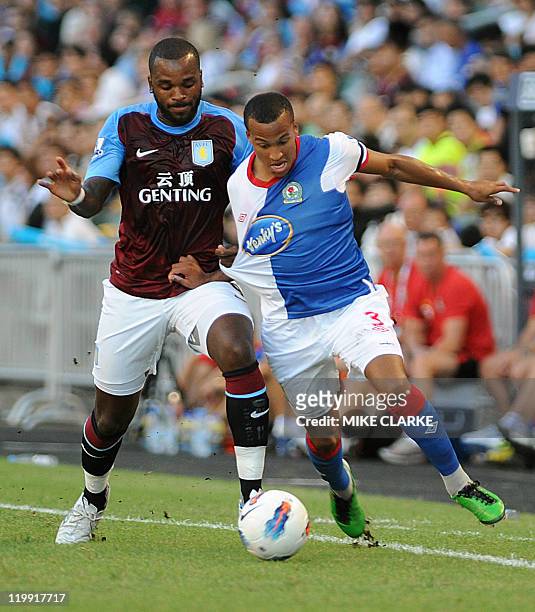 Martin Olsson of Blackburn battles for the ball with Darren Bent of Aston Villa during their Barclays Asia Trophy football match at Hong Kong stadium...