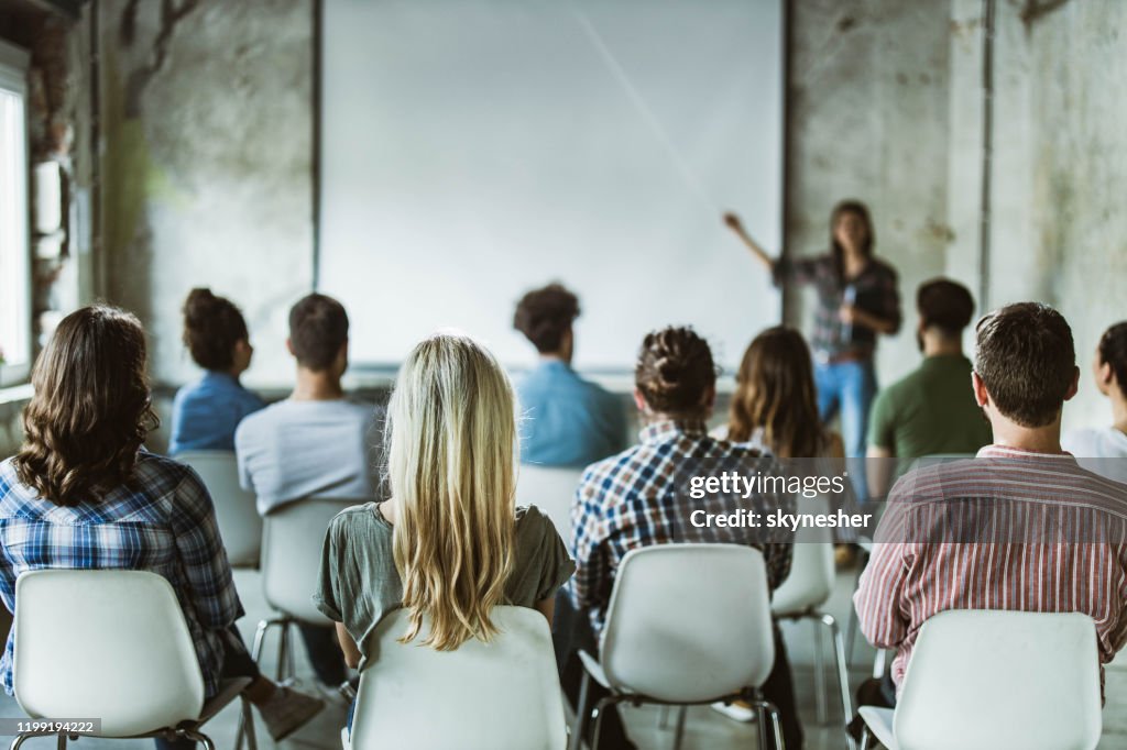 Back view of design professionals having training class in the office.