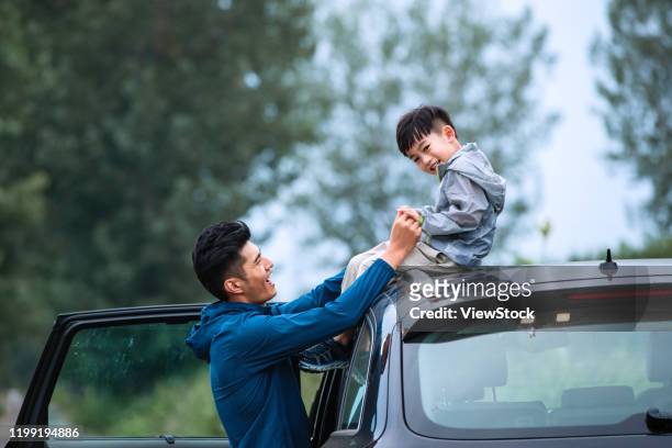 father and son happy east - china east asia stock-fotos und bilder