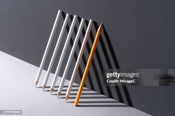 pencils with shadow triangle shape - arranging ideas stock-fotos und bilder