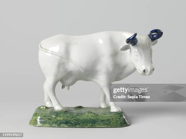 Cow with blue horns, on rectangular base with beveled corners, Faience image. A cow stands on a rectangular pedestal with beveled corners. The cow...