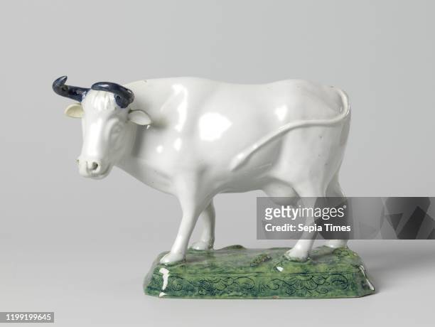 Cow with blue horns, on a rectangular base with beveled corners, Faience image. A cow stands on a rectangular pedestal with beveled corners. The cow...