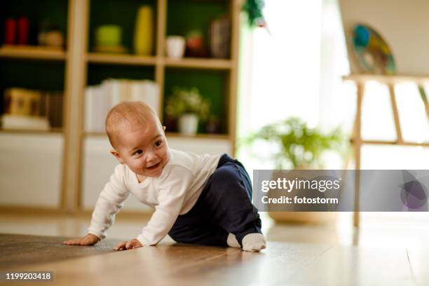 cute baby girl deciding where to crawl - crawling stock pictures, royalty-free photos & images