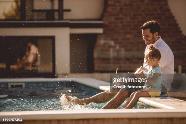 vader en dochter grappige tijd bij het zwembad - vakantiehuis stockfoto's en -beelden