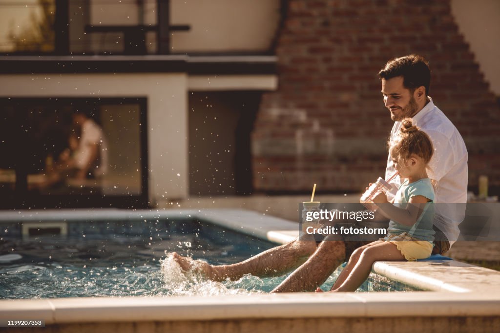 Father and daughter funny time by the pool