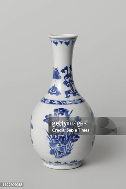 Pear-shaped bottle vase with flowering plants, Bottle-shaped porcelain vase with a pear-shaped body and spreading neck, painted in underglaze blue....