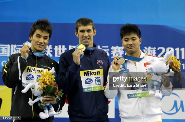 Gold medalist Michael Phelps of the United States poses with silver medalist Takeshi Matsuda of Japan and bronze medalist Peng Wu of China after the...