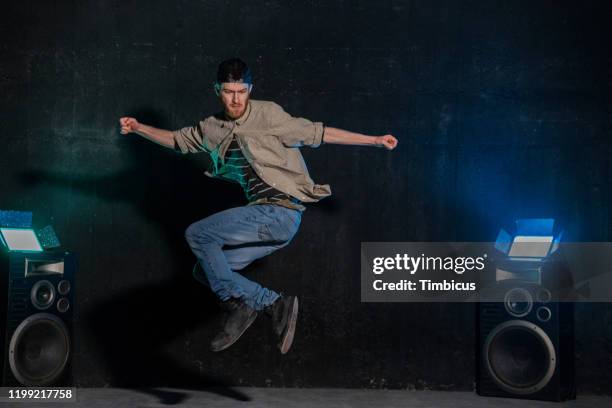 jumping young dancer in studio - all hip hop models stock pictures, royalty-free photos & images