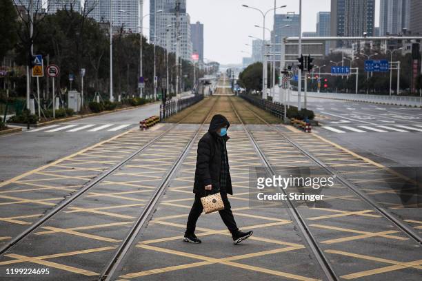 Resident walks across an empty track on February 7, 2020 in Wuhan, Hubei province, China. The number of those who have died from the Wuhan...