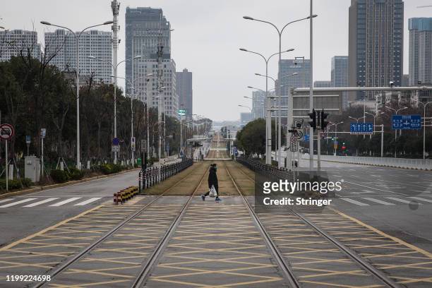 Resident walks across an empty track on February 7, 2020 in Wuhan, Hubei province, China. The number of those who have died from the Wuhan...