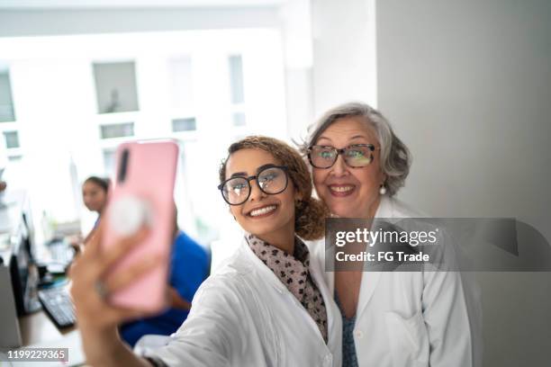 doctors taking a selfie at the hospital - doctor selfie stock pictures, royalty-free photos & images