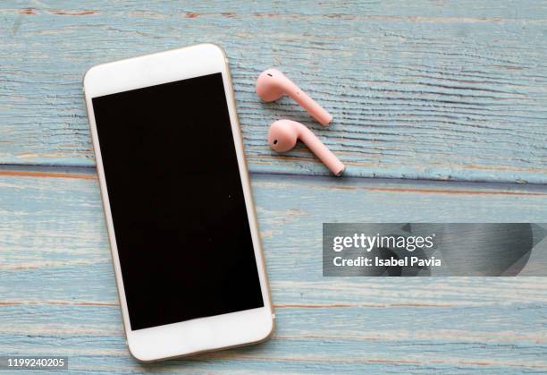 smart phone and wireless headphones - headphones white background stock pictures, royalty-free photos & images