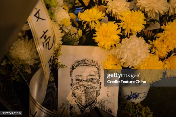 Card with a portrait of Dr. Li Wenliang at Li's hospital in Wuhan in central China's Hubei province Friday, Feb. 07, 2020. Li, regarded a...