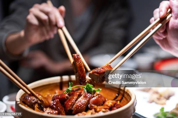 tasting hong kong cuisine - chopsticks stock-fotos und bilder