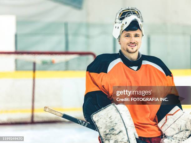 pro hockey goalie - man wearing sports jersey stock pictures, royalty-free photos & images