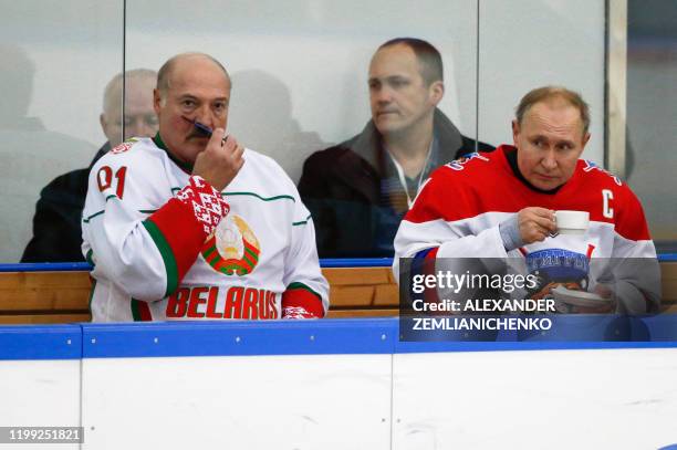 Russian President Vladimir Putin and Belarusian President Alexander Lukashenko take part in an ice hockey match at Rosa Khutor outside the Black Sea...