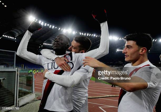 Musa Barrow of Bologna FC celebrates with team-mate Riccardo Orsolini after scoring the team's third goal during the Serie A match between AS Roma...