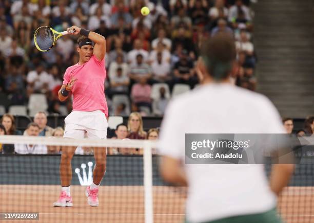 Roger Federer of Switzerland and Rafael Nadal of Spain play a tennis match at Cape Town Stadium as part of an exhibition game held to support the...