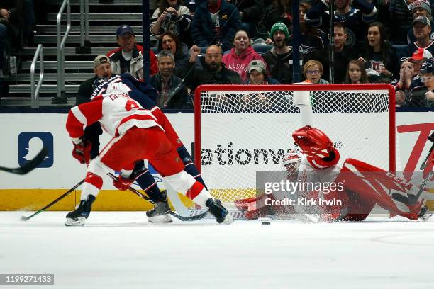 Jimmy Howard of the Detroit Red Wings stops a shot by Markus Nutivaara of the Columbus Blue Jackets during the first period of the game on February...