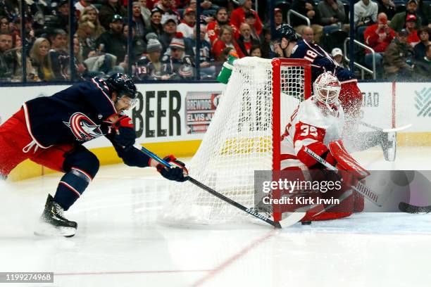 Jimmy Howard of the Detroit Red Wings stops a wrap-around shot by Nick Foligno of the Columbus Blue Jackets during the second period of the game on...