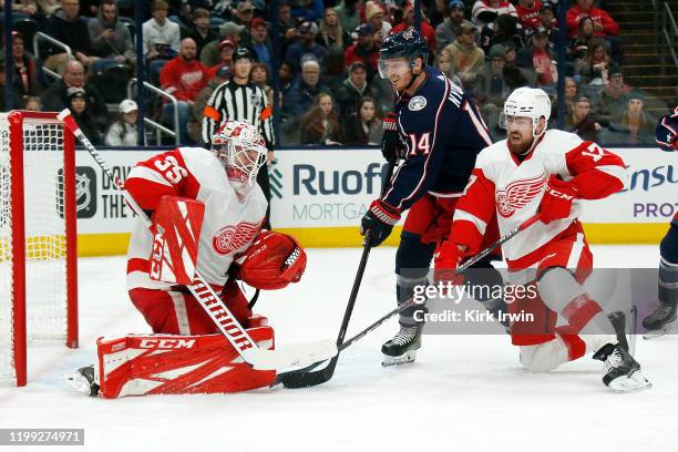 Jimmy Howard and Filip Hronek of the Detroit Red Wings defend a shot by Gustav Nyquist of the Columbus Blue Jackets during the second period of the...