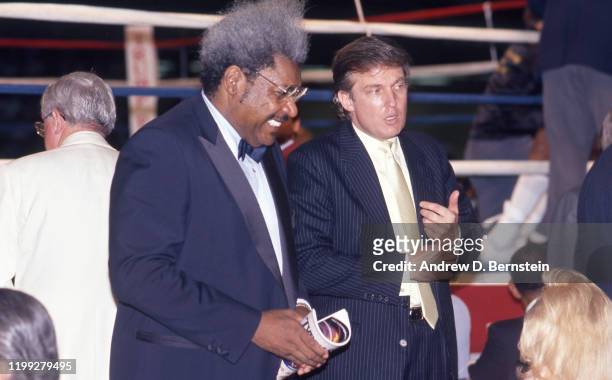 Don King speaks with Donald Trump at the Mike Tyson vs. Michael Spinks fight on June 27, 1988 in Atlantic City, New Jersey.