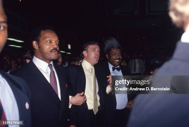 Jesse Jackson, Donald Trump and Don King speak at the Mike Tyson vs. Michael Spinks fight on June 27, 1988 in Atlantic City, New Jersey.