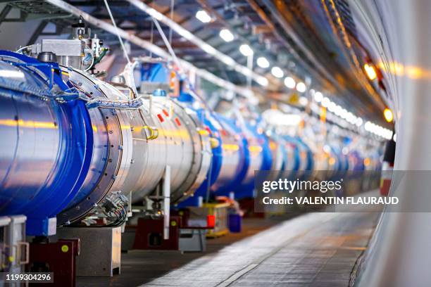 Some of the 1232 dipole magnets that bend the path of accelerated protons are pictured in the Large Hadron Collider in a tunnel of the European...