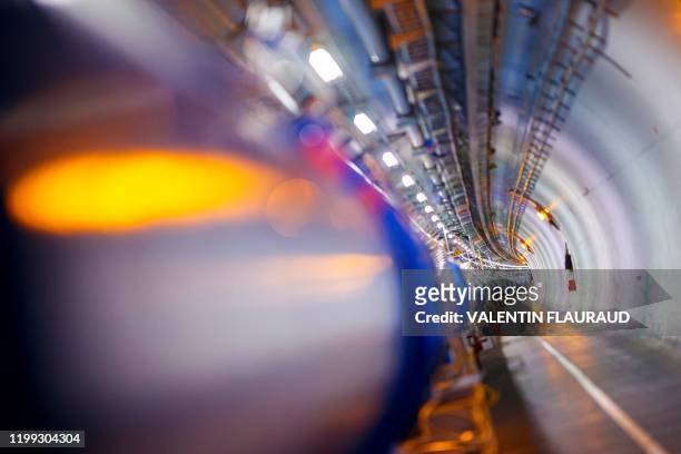Some of the 1232 dipole magnets that bend the path of accelerated protons are pictured in the Large Hadron Collider in a tunnel of the European...