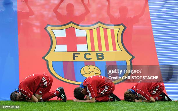 Children peformance in front of a FC Barcelona banner prior to the Audi Cup football match FC Barcelona vs SC International de Porto Alegre in...