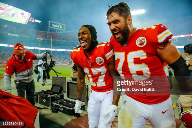 Mecole Hardman of the Kansas City Chiefs and Laurent Duvernay-Tardif of the Kansas City Chiefs laugh as they exit the field following the 51-31...