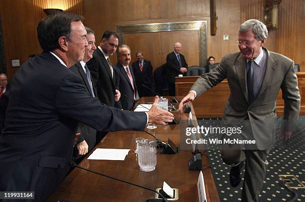 Michael Duke , president and CEO of Wal-Mart Stores Inc., greets committee chairman U.S. Sen. Max Baucus prior to a hearing July 27, 2011 in...