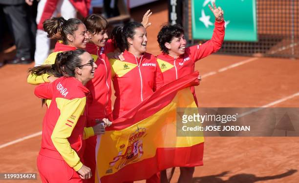 Spain's players Georgina Garcia Perez, Sara Sorribes, Aliona Bolsova, Lara Arruabarrena and Carla Suarez celebrate after Suarez's Fed Cup qualifier...