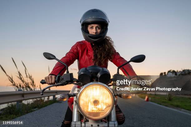 woman drives on a motorcycle - motorcycle riding stock pictures, royalty-free photos & images