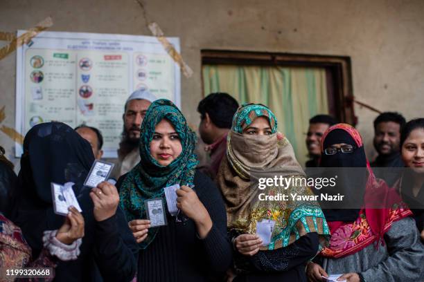 Indian Muslim women wait in queue to cast their votes outside a polling station on February 8, 2020 in Delhi, India. The Muslim-majority locality has...